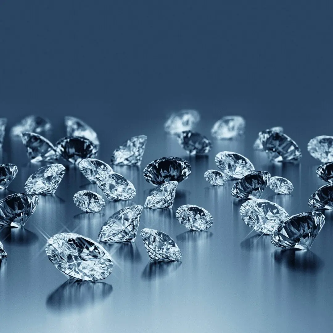 Sparkling diamonds scattered on a reflective surface.