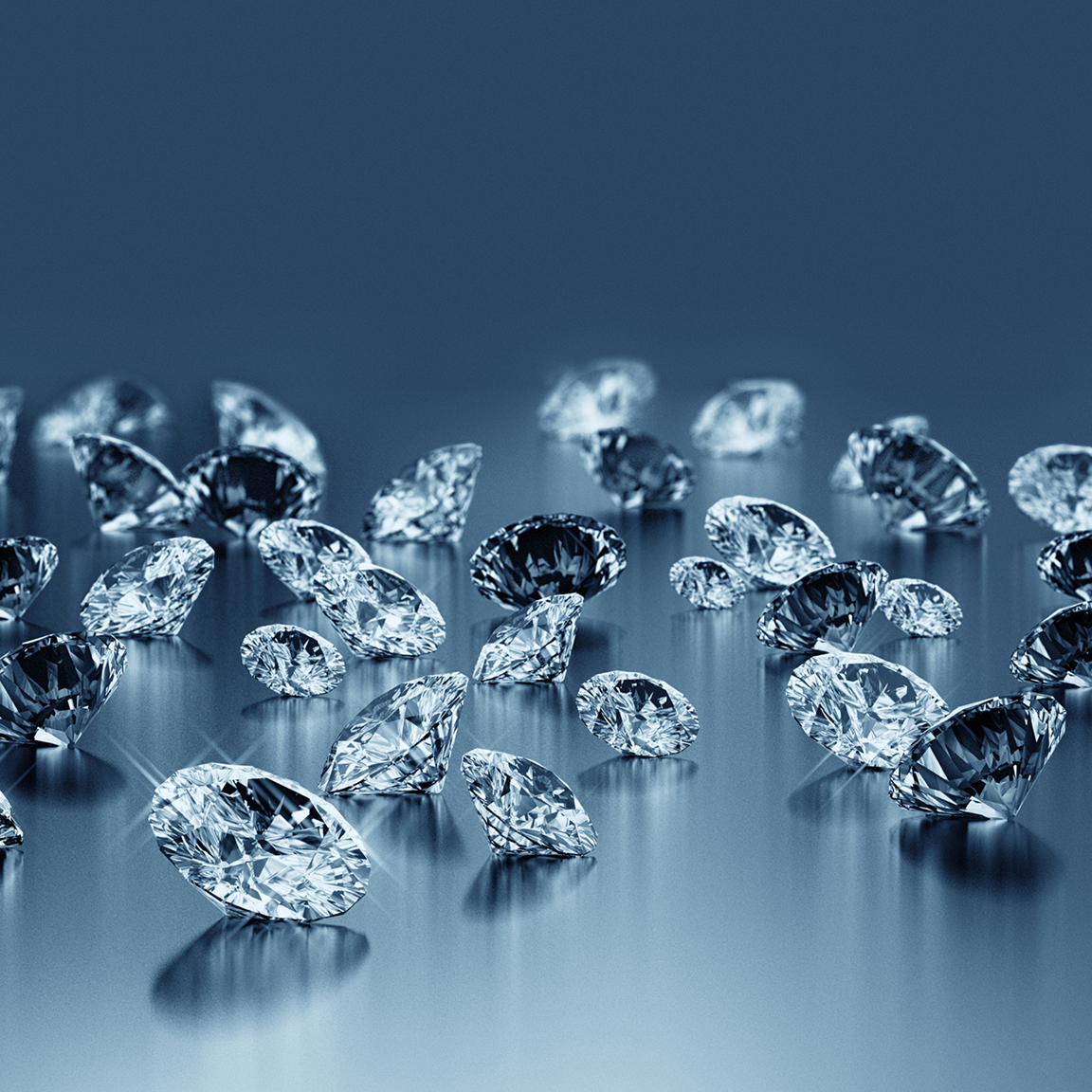 Sparkling diamonds scattered on a reflective surface.